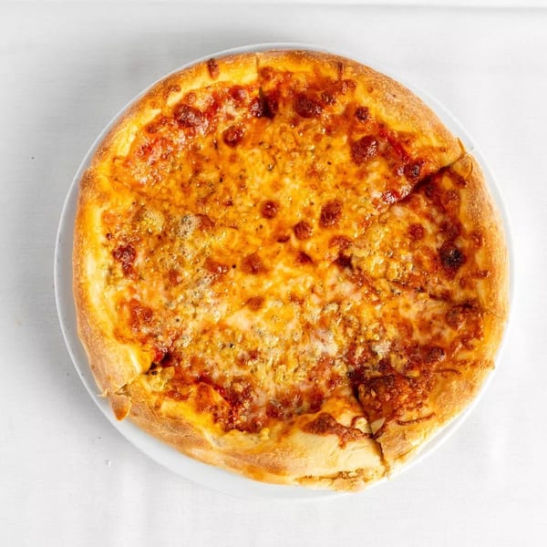 A whole cheese pizza with a golden crust, cut into slices, on a white plate.